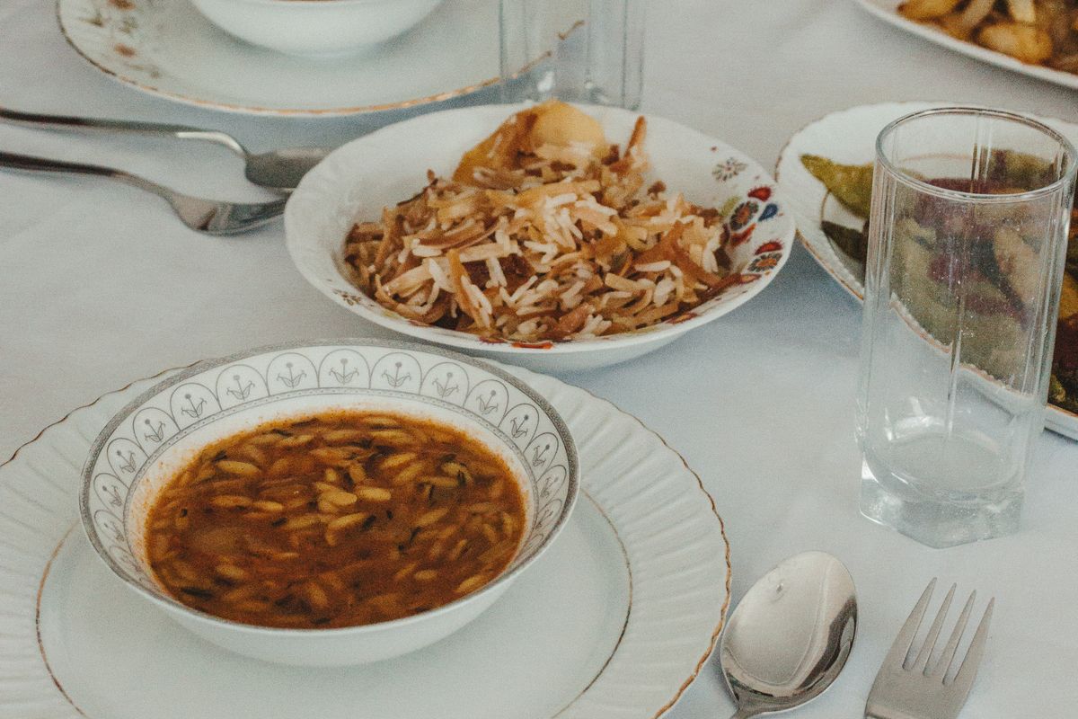 A finished meal of soup and rice served on a laid table